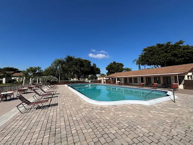 a view of a house with swimming pool and sitting area
