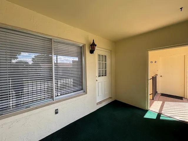 a view of a livingroom with an empty space and a window