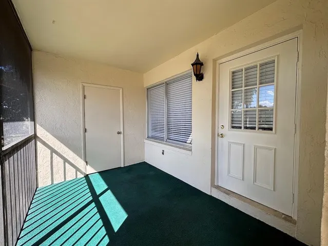 a view of a porch with wooden floor and stairs