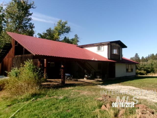 31997 2nd Fork Road Ola, ID 83657 - Photo 1 of 47 House with a red metal roof, covered carport, and wood siding accents
