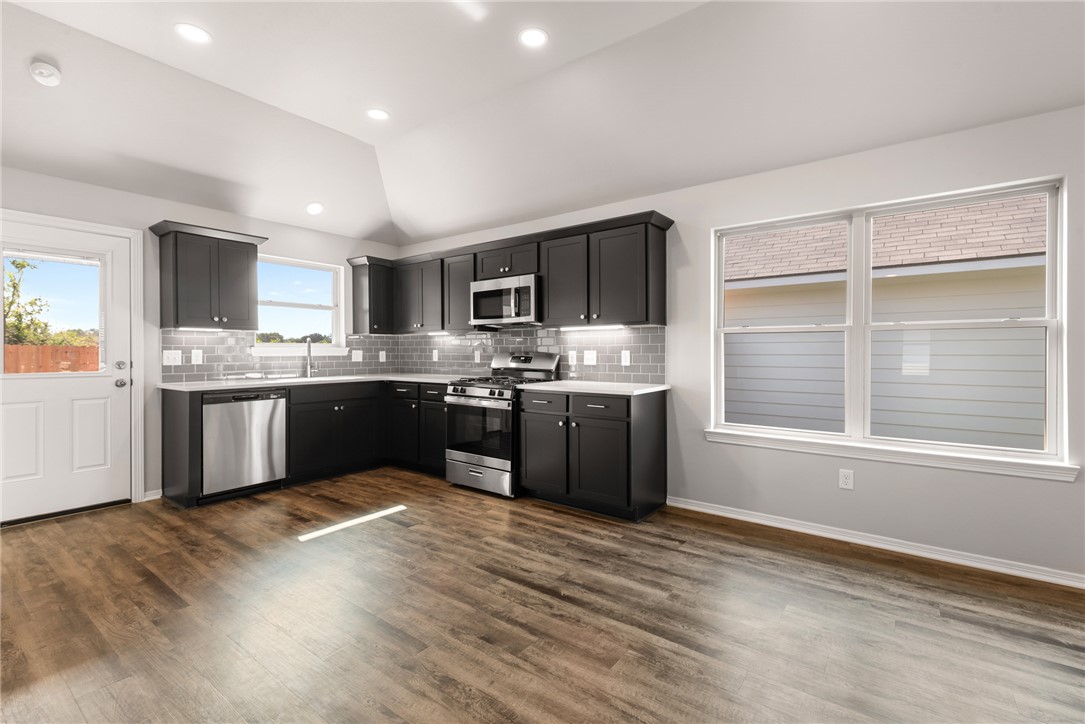 2869 Messenger Way Bryan, TX 77803 - Photo 8 of 23 a kitchen with stainless steel appliances granite countertop a sink counter space cabinets and a window