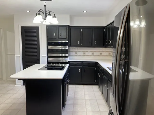 a kitchen with a sink and a refrigerator