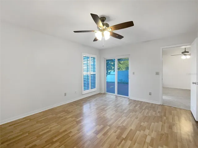 wooden floor in an empty room with a window