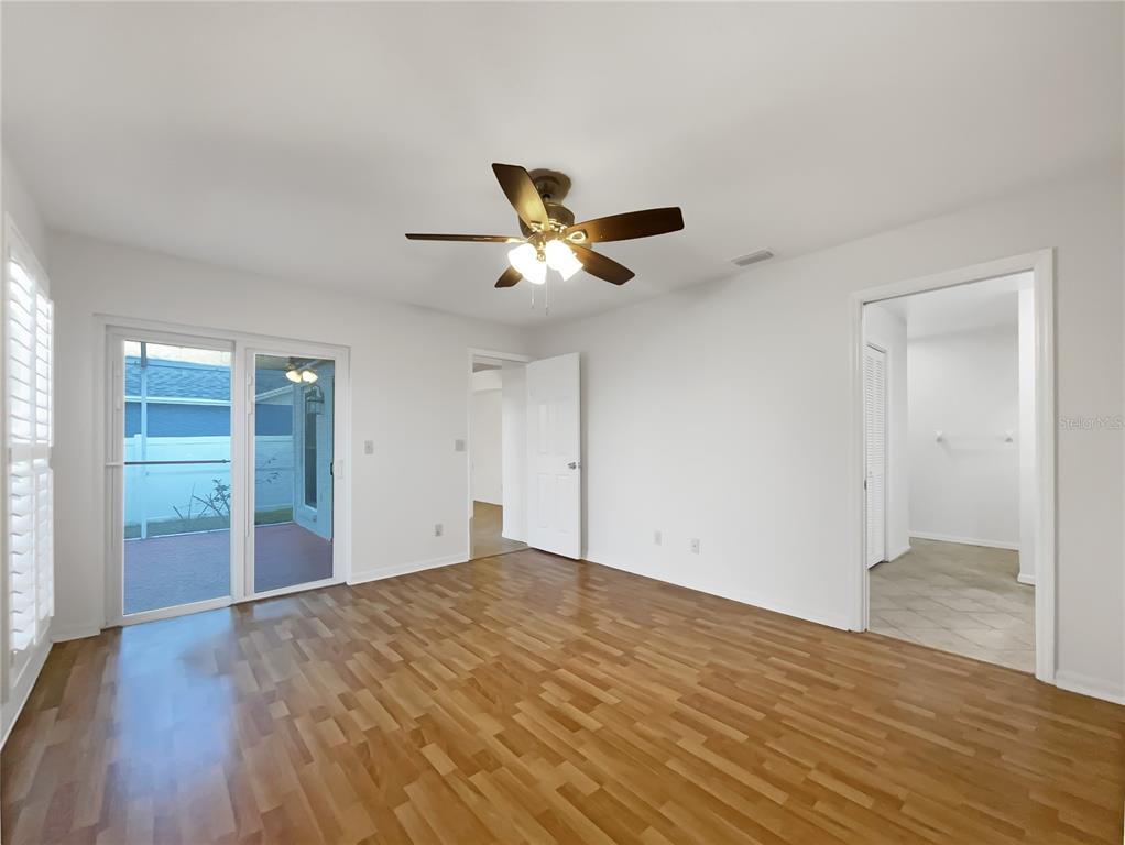 605 Sand Ridge Drive Valrico, FL 33594 - Photo 12 of 26 an empty room with wooden floor and a ceiling fan