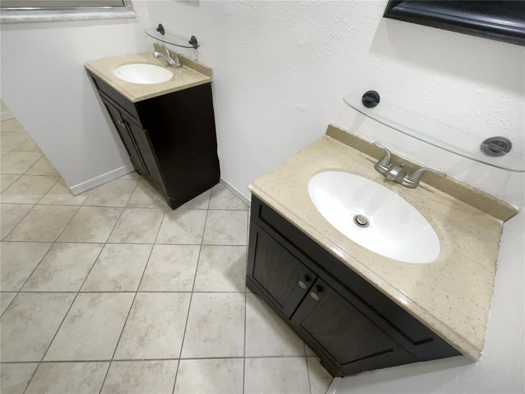 605 Sand Ridge Drive Valrico, FL 33594 - Photo 13 of 26 a bathroom with a sink and a mirror