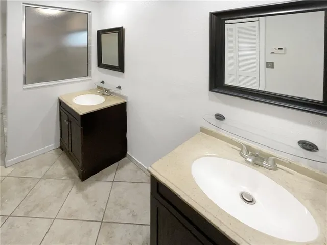 a bathroom with a sink vanity and mirror