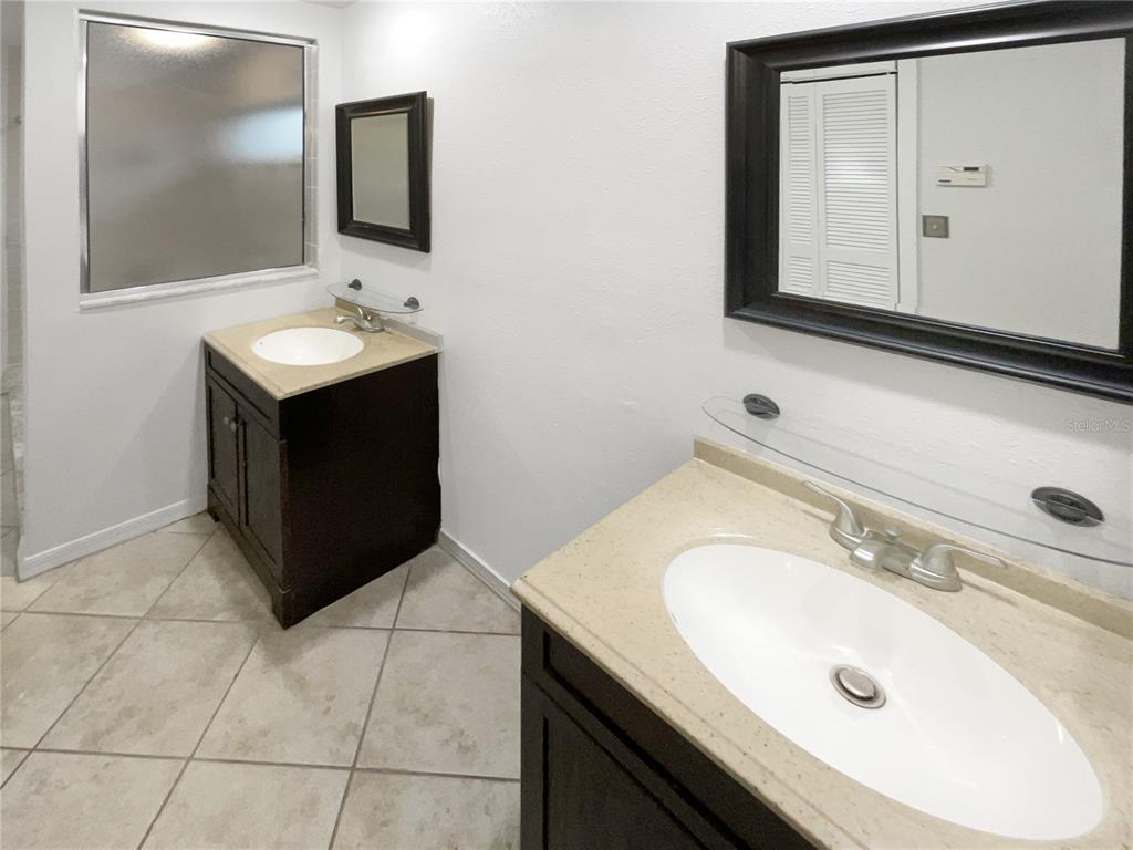 605 Sand Ridge Drive Valrico, FL 33594 - Photo 14 of 26 a bathroom with a sink vanity and mirror