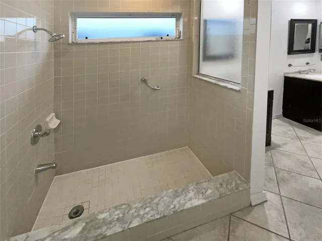 a bathroom with a tub and a shower