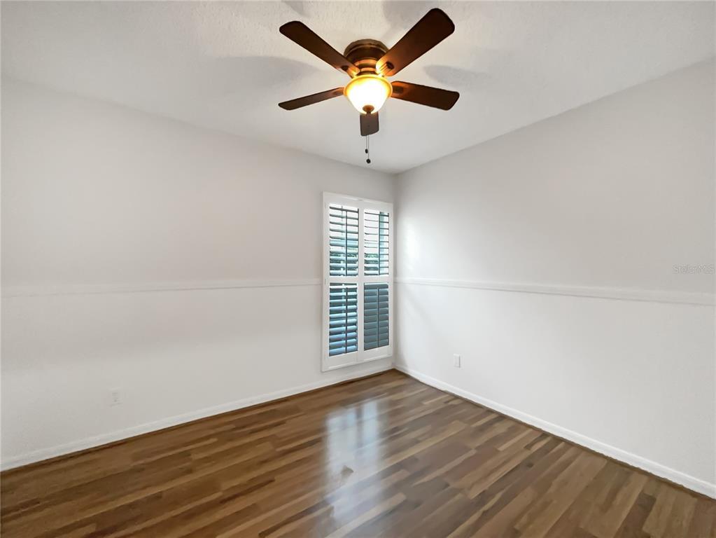 605 Sand Ridge Drive Valrico, FL 33594 - Photo 17 of 26 an empty room with wooden floor and windows