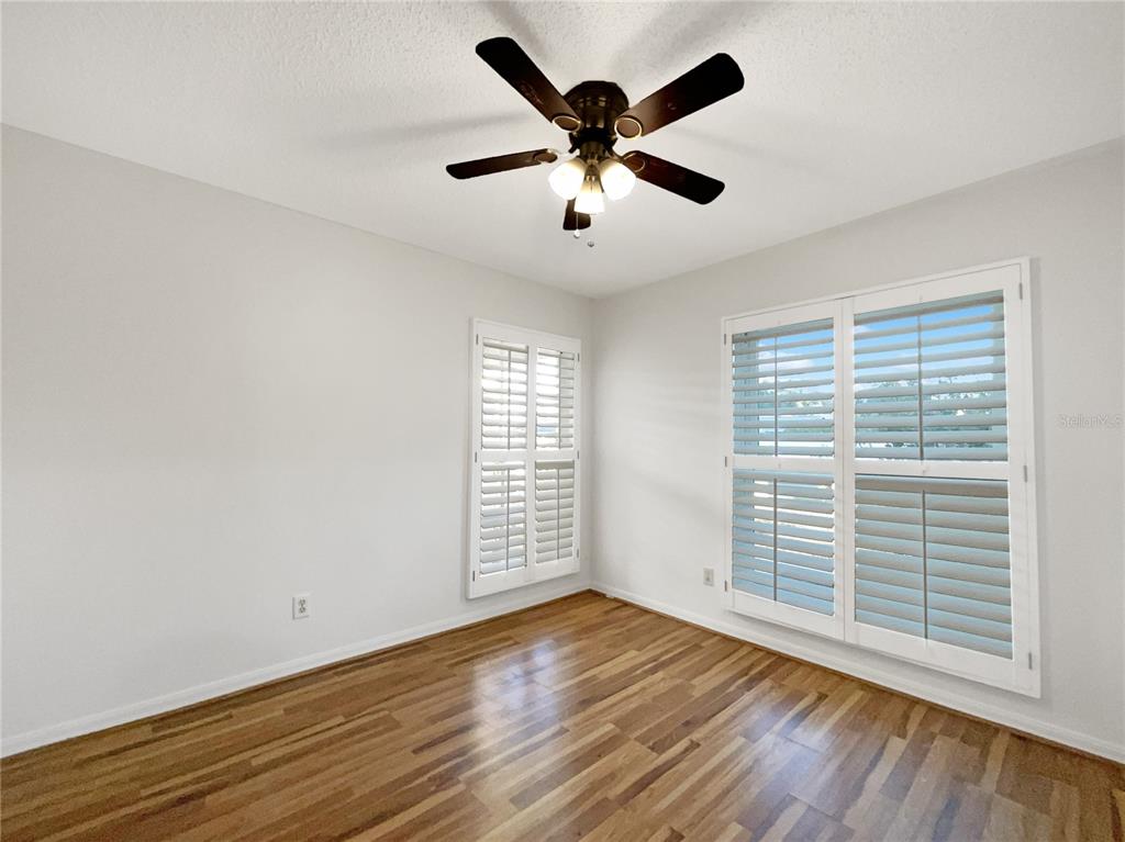 605 Sand Ridge Drive Valrico, FL 33594 - Photo 21 of 26 a view of empty room with wooden floor and fan