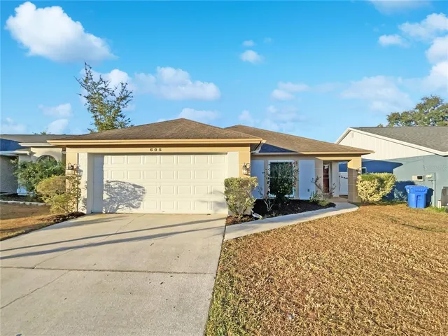 a view of a house with sitting area and garden