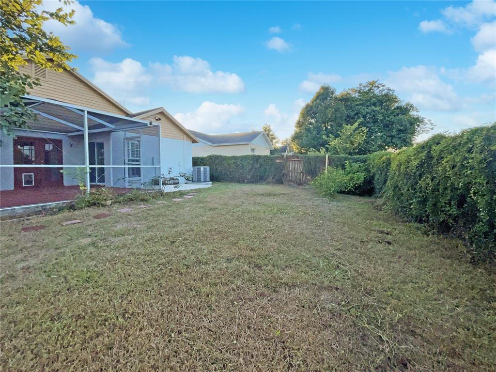 605 Sand Ridge Drive Valrico, FL 33594 - Photo 24 of 26 a view of a backyard with large trees and a barn