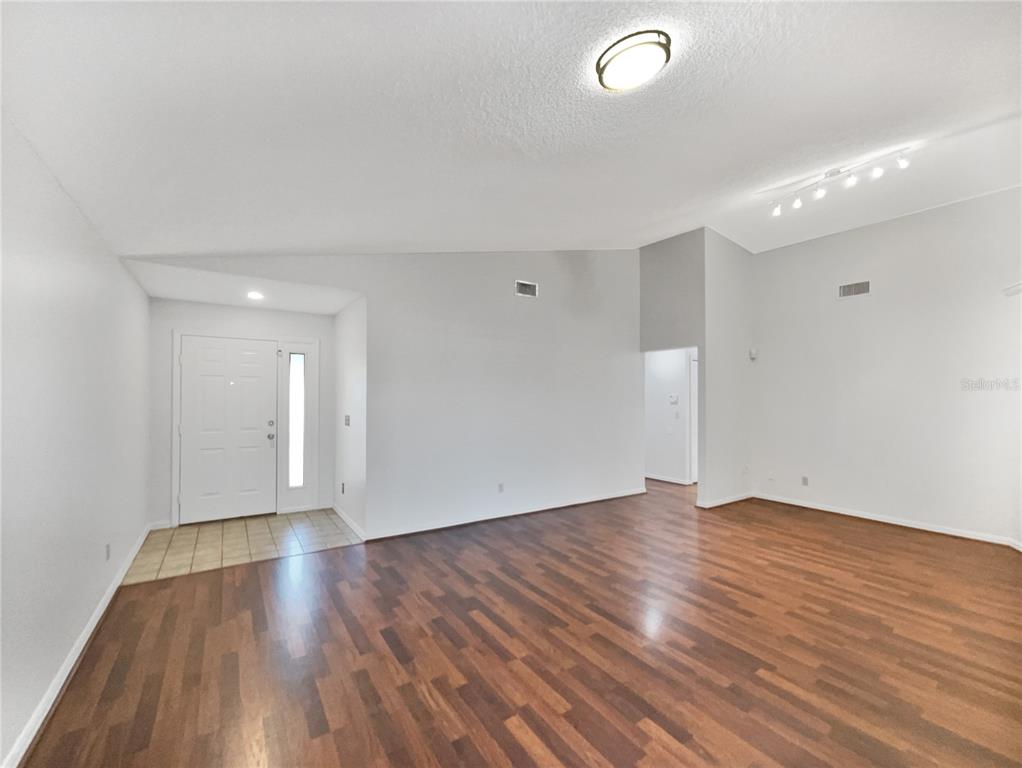 605 Sand Ridge Drive Valrico, FL 33594 - Photo 6 of 26 an empty room with wooden floor and windows