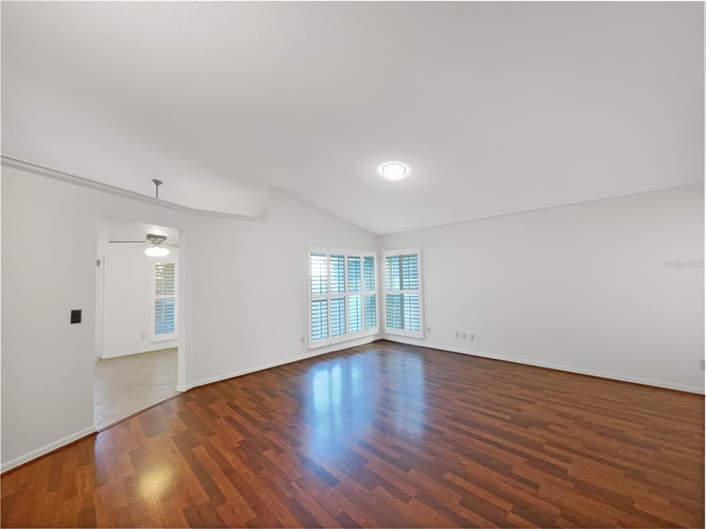 605 Sand Ridge Drive Valrico, FL 33594 - Photo 7 of 26 a view of an empty room with wooden floor and window