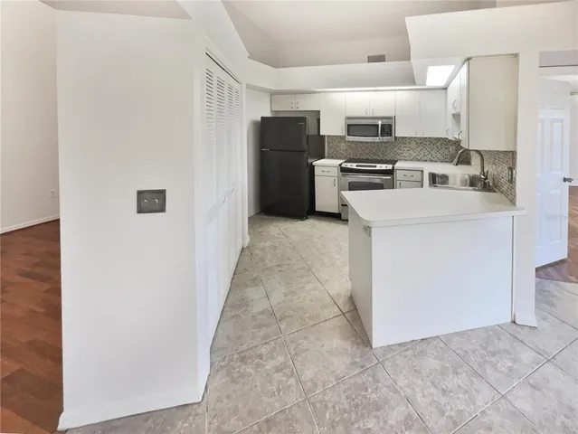 a kitchen with refrigerator and oven