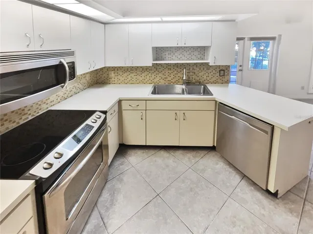 a kitchen with a stove and a microwave