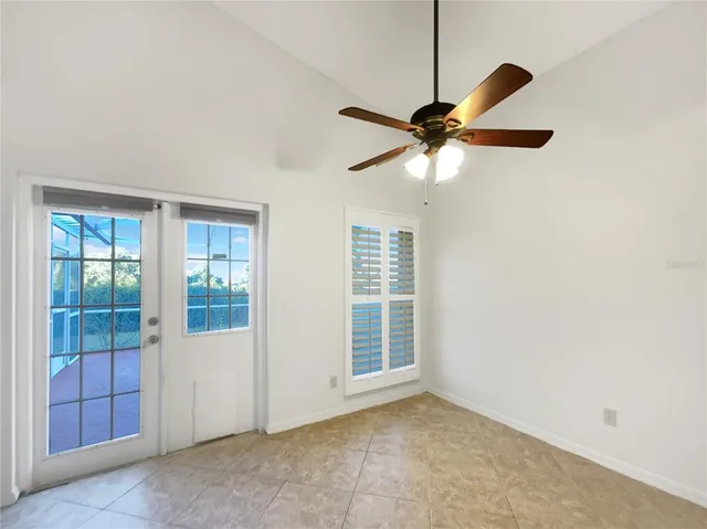 a view of a livingroom with a ceiling fan and window