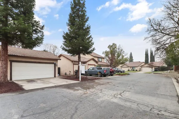 a view of a house with a yard and garage