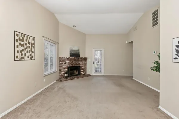 a view of livingroom with furniture and a fireplace