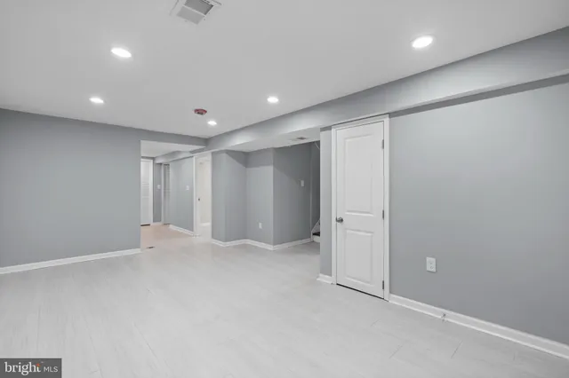 an empty room with a stairs and white doors