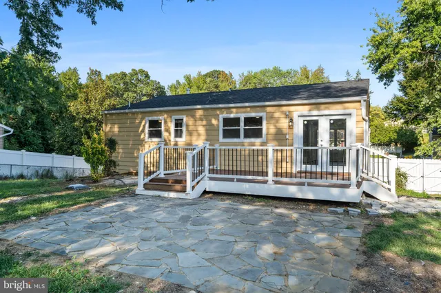 a view of a chair and table in backyard of the house