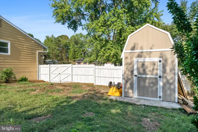 a backyard of a house with a yard and outdoor seating
