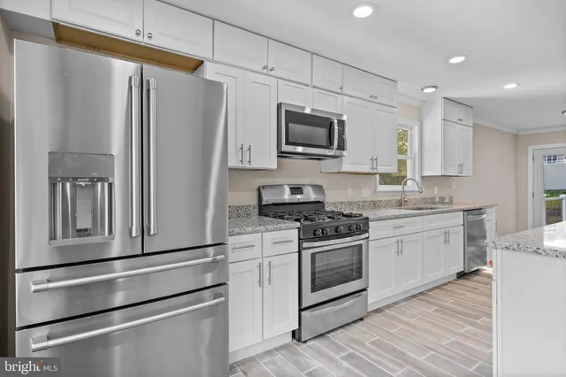 a kitchen with sink cabinets and wooden floor