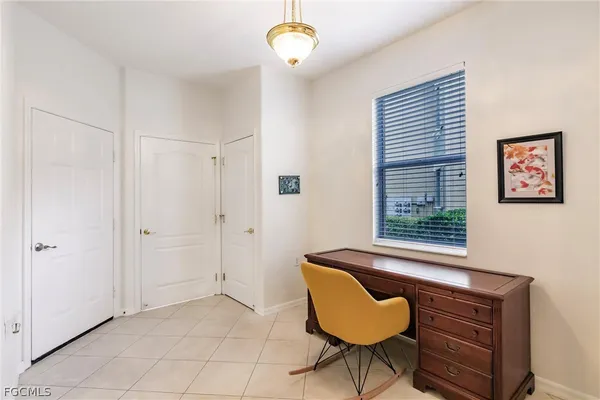 a view of an empty room with a window and cabinet