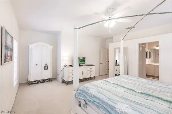 a bedroom with a bed and a large mirror