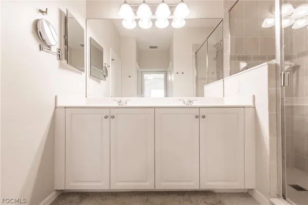 a bathroom with a shower sink and mirror