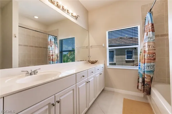 a bathroom with a granite countertop sink mirror vanity and a toilet