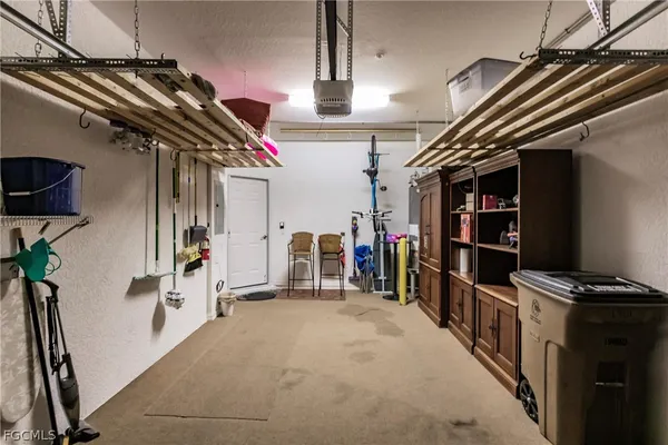 an aerial view of a house with yard swimming pool and lake view