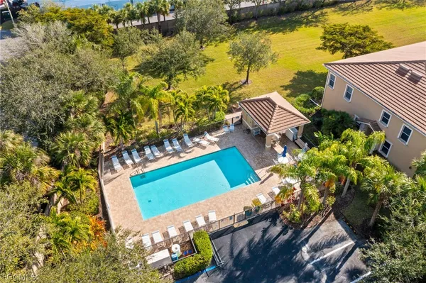 a aerial view of a house with swimming pool and ocean view