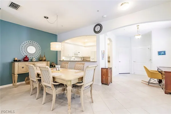 a dining room with furniture and a large window