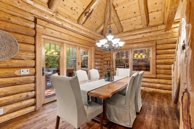 a view of a dining room with furniture wooden floor and chandelier