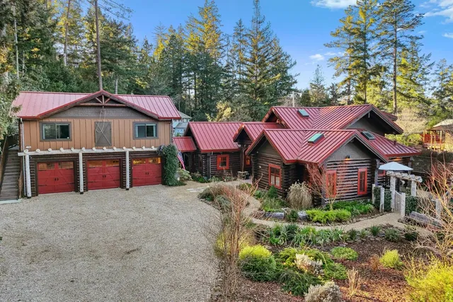 a large house with a big yard and large trees