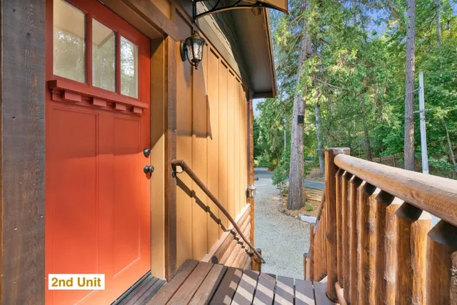 a kitchen with stainless steel appliances kitchen island granite countertop a table chairs and a refrigerator