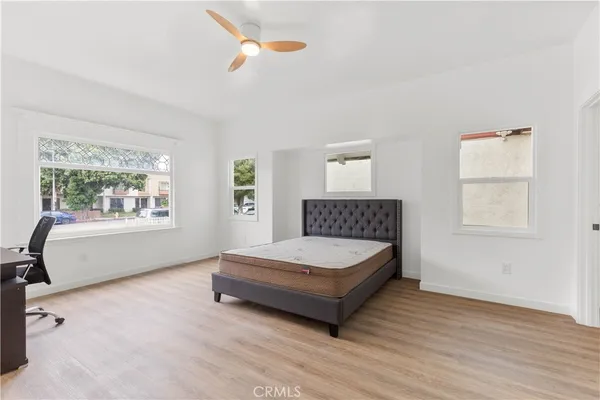 a spacious bedroom with a bed and a window