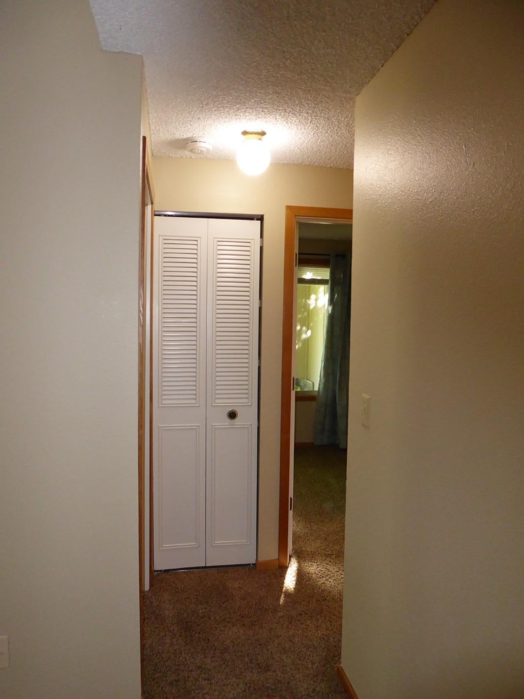1700 Northeast Wells Acres Road, Unit 15 Bend, OR 97701 - Photo 8 of 17 Hallway to BRs and bath