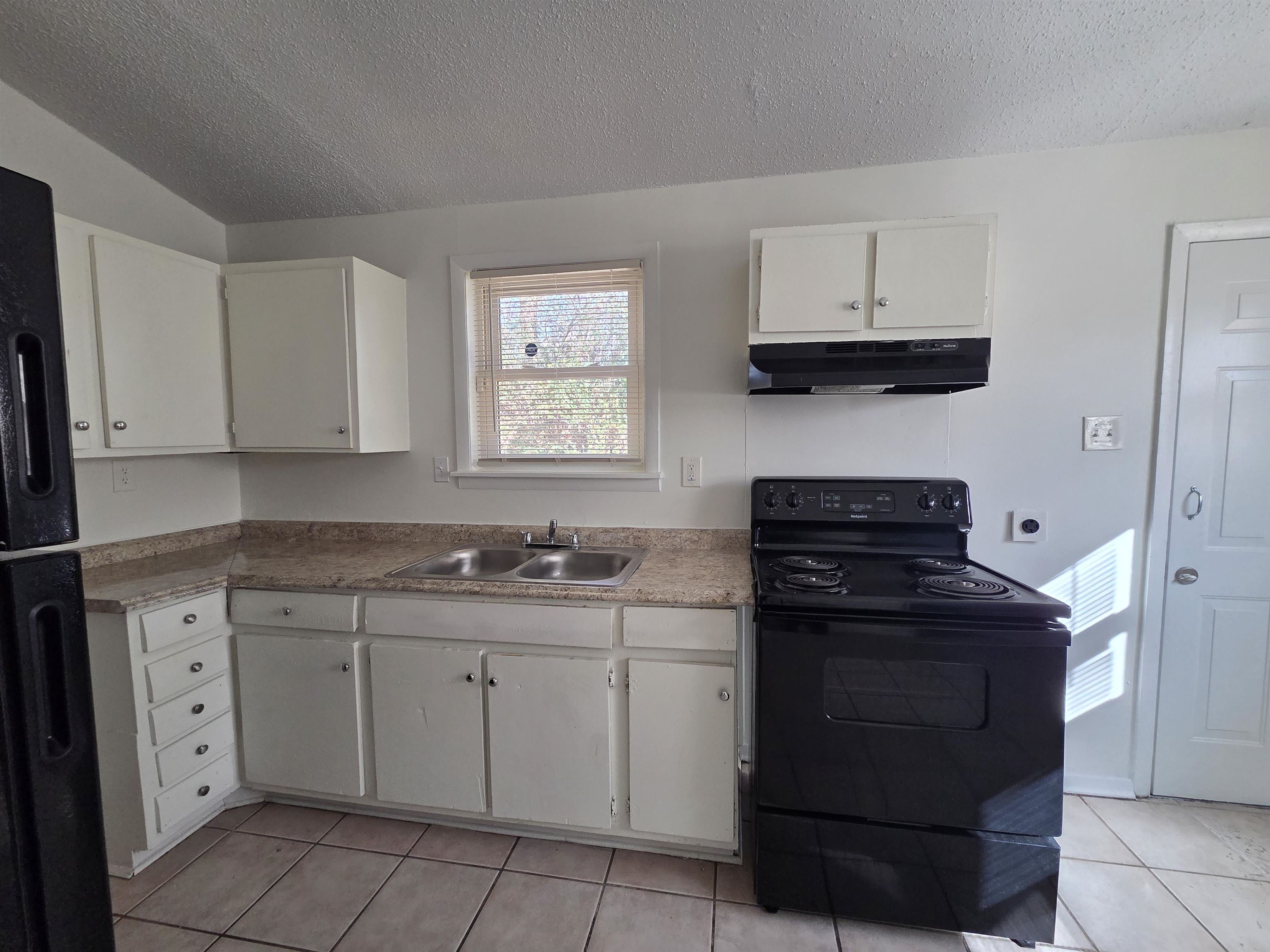 4638 Appleville Street Memphis, TN 38109 - Photo 12 of 23 a kitchen with white cabinets and appliances