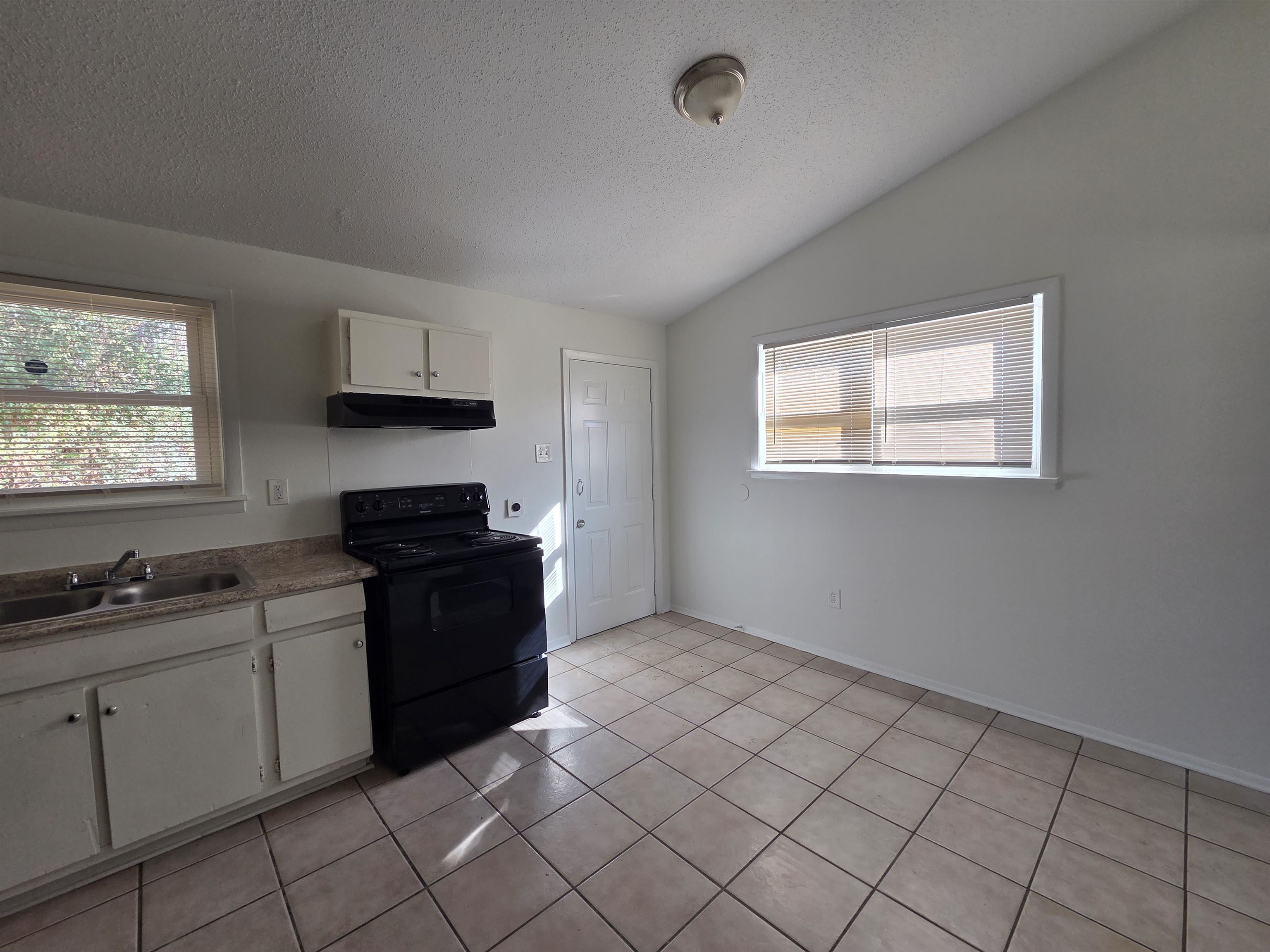 4638 Appleville Street Memphis, TN 38109 - Photo 13 of 23 a kitchen with a sink and cabinets
