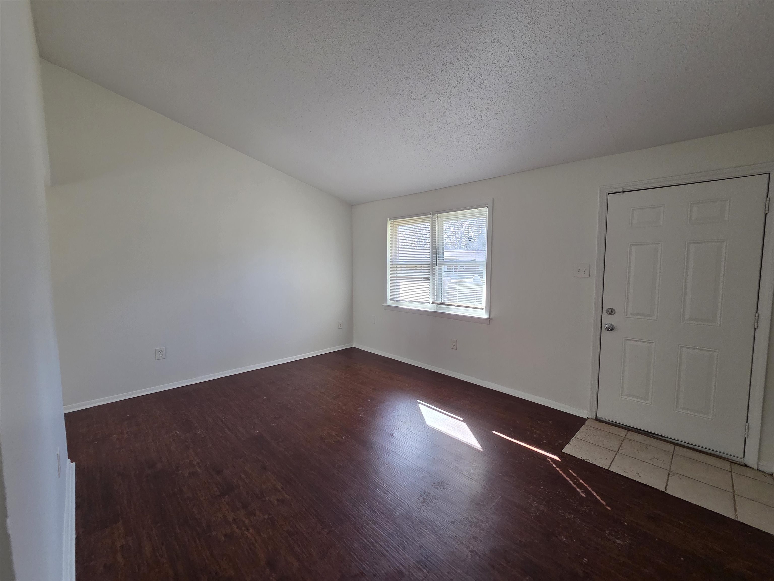4638 Appleville Street Memphis, TN 38109 - Photo 14 of 23 an empty room with wooden floor and windows