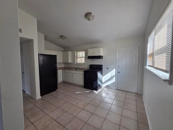a kitchen with stainless steel appliances a refrigerator sink and cabinets