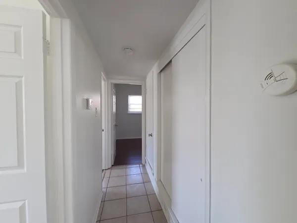 a view of a hallway with wooden floor