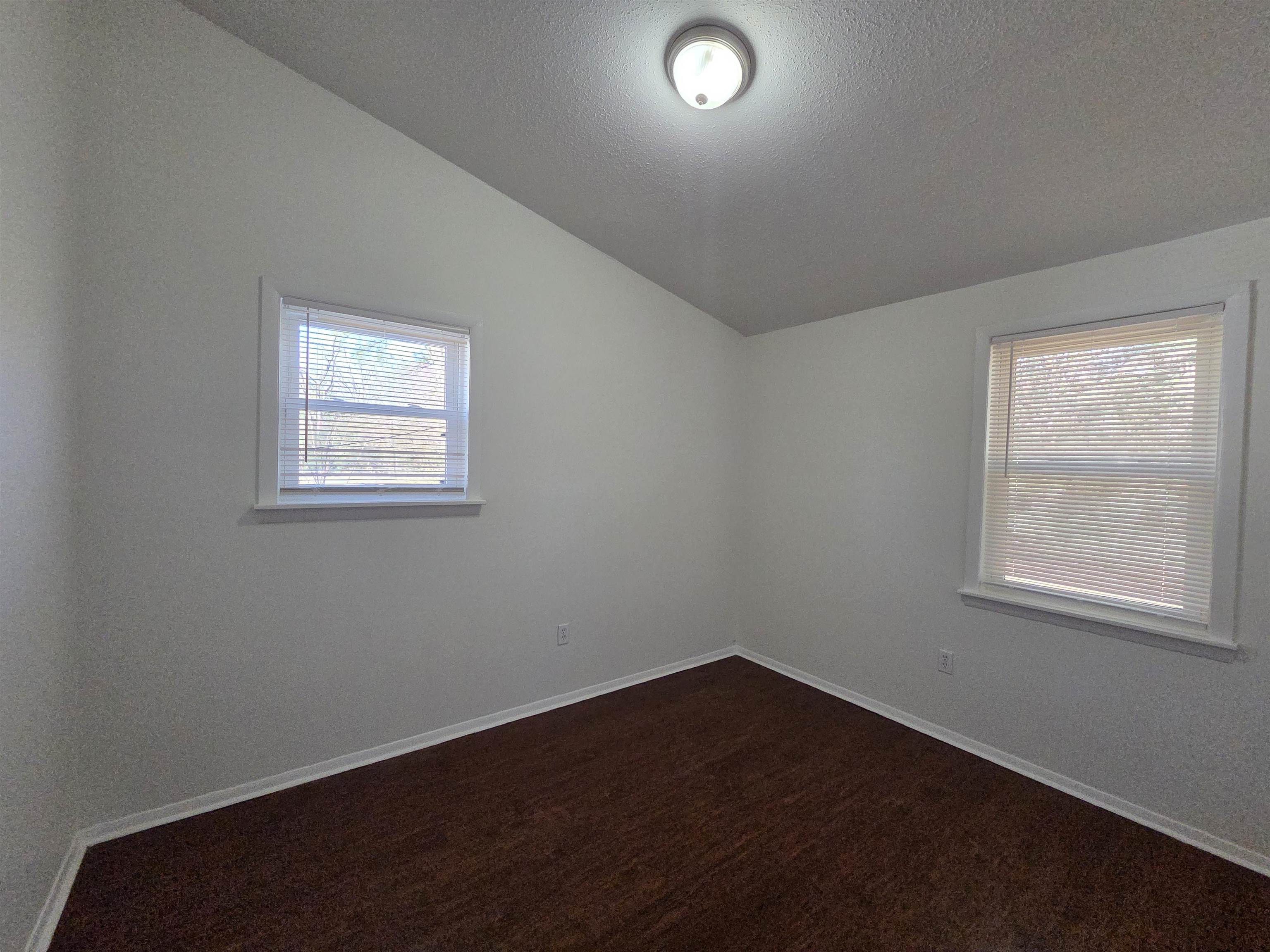 4638 Appleville Street Memphis, TN 38109 - Photo 6 of 23 an empty room with wooden floor and windows