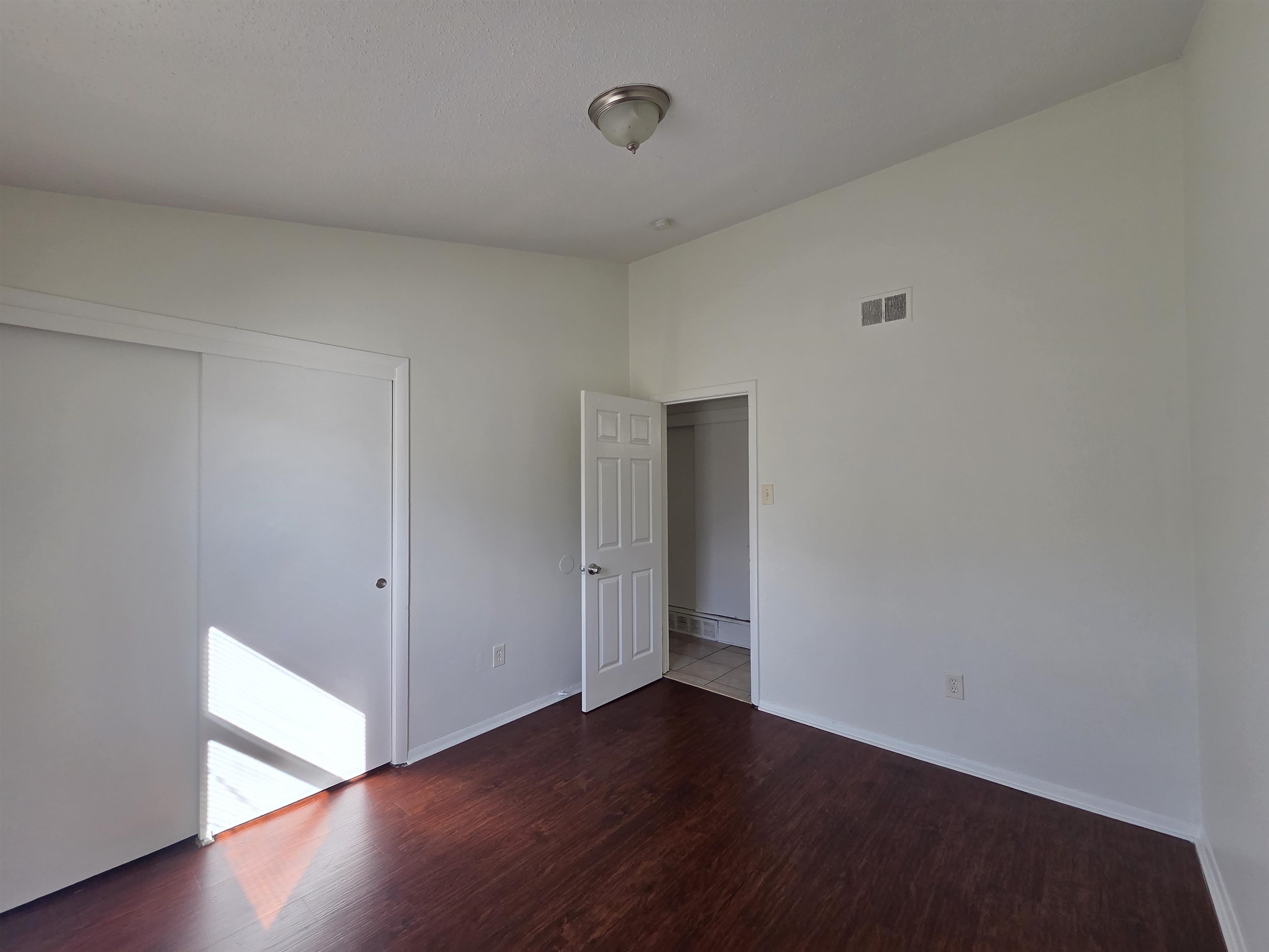 4638 Appleville Street Memphis, TN 38109 - Photo 8 of 23 a view of an empty room with wooden floor