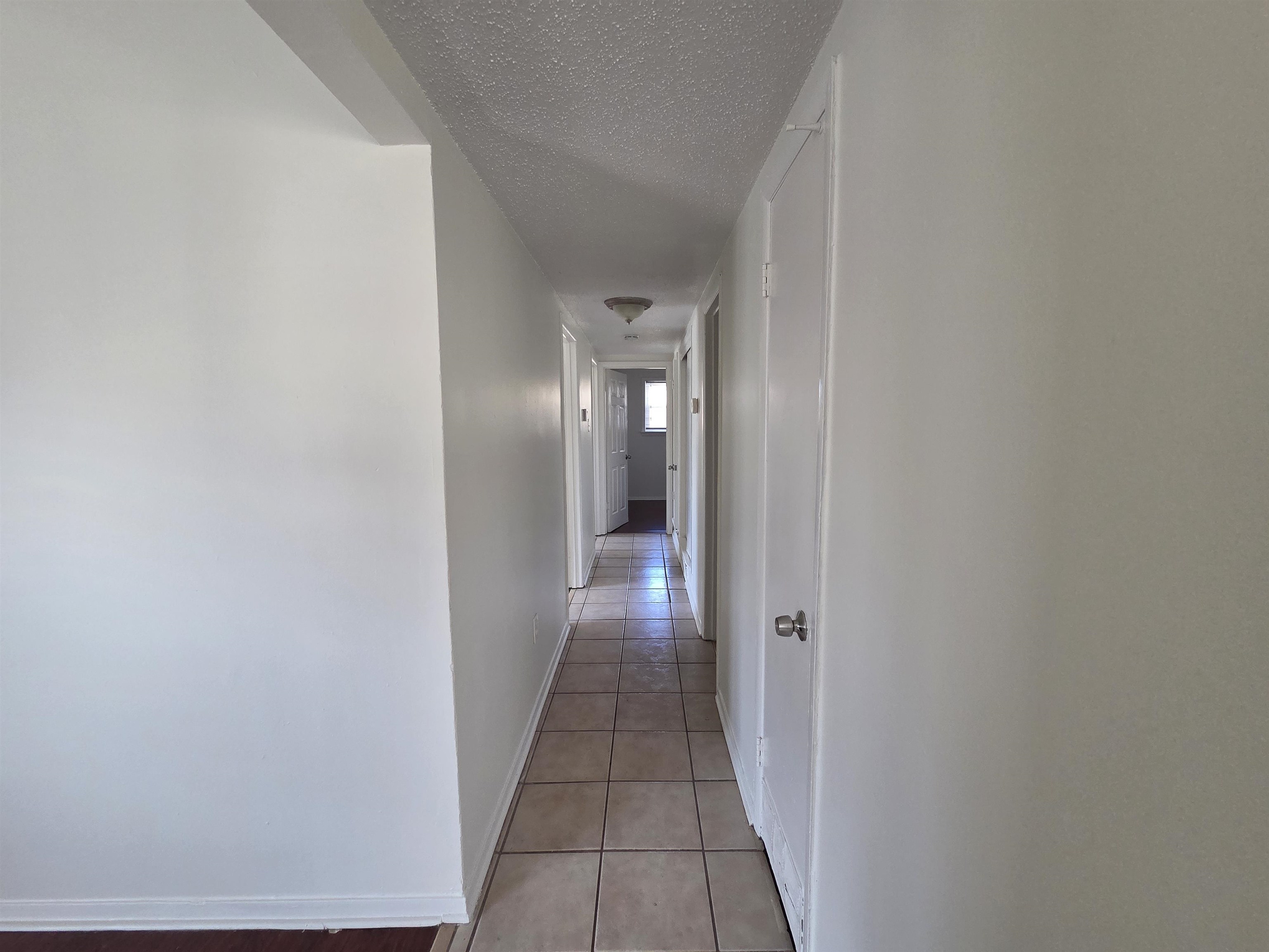 4638 Appleville Street Memphis, TN 38109 - Photo 10 of 23 a view of a hallway with wooden floor
