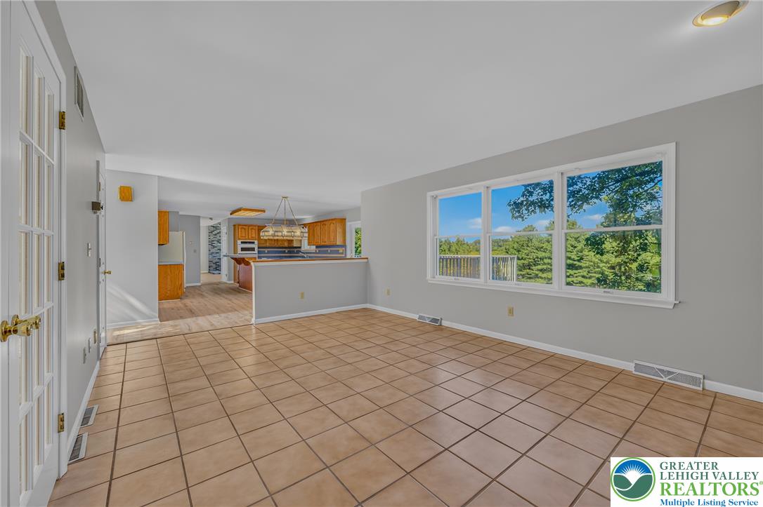 630 Clearfield Road Nazareth, PA 18064 - Photo 28 of 100 Tiled flooring and large windows create a bright foundation in this airy living space.