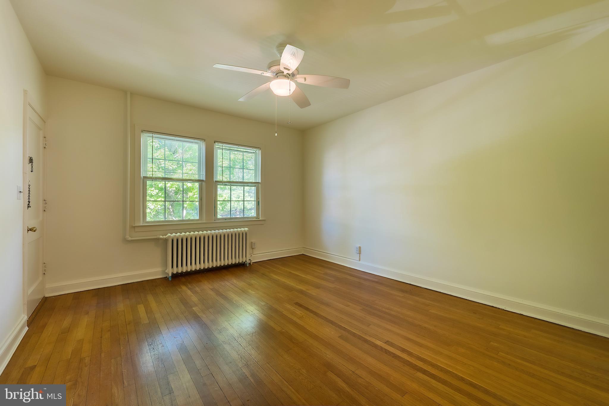 2341 40th Street Northwest, Unit 4 Washington, DC 20007 - Photo 11 of 21 a view of an empty room with wooden floor and a window