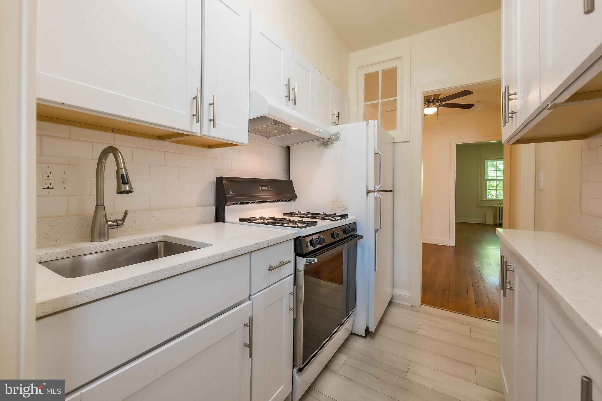 2341 40th Street Northwest, Unit 4 Washington, DC 20007 - Photo 5 of 21 a kitchen with a sink stove and refrigerator